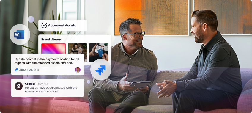 Two men discussing assets using a tablet